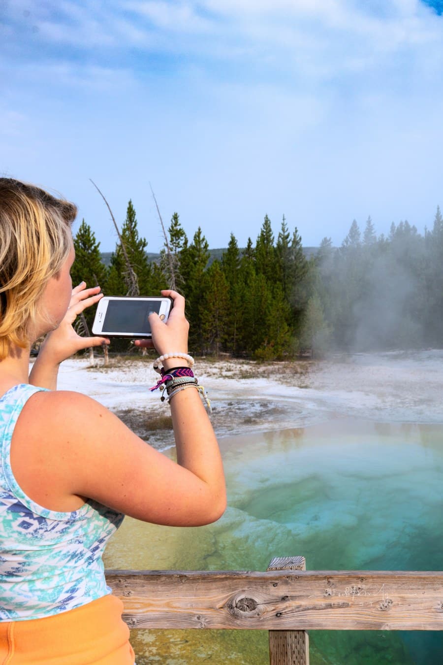 Teenager Taking Pictures on Vacation in Yellowstone National Park, Morning Glory Geyser