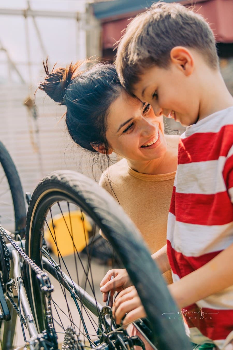 young boy Repairing bikes with his mom