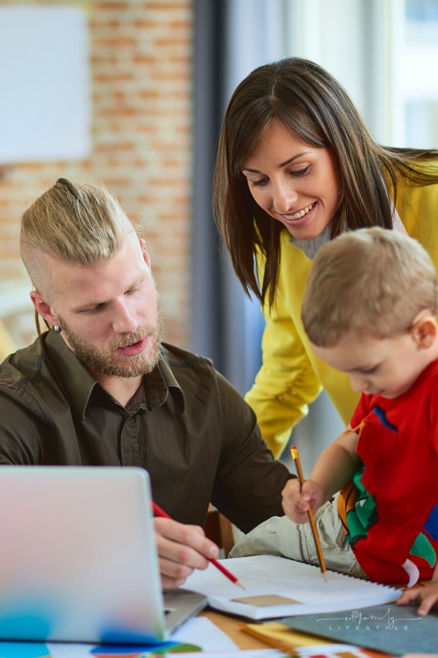 father and mother of young son working on family business documents