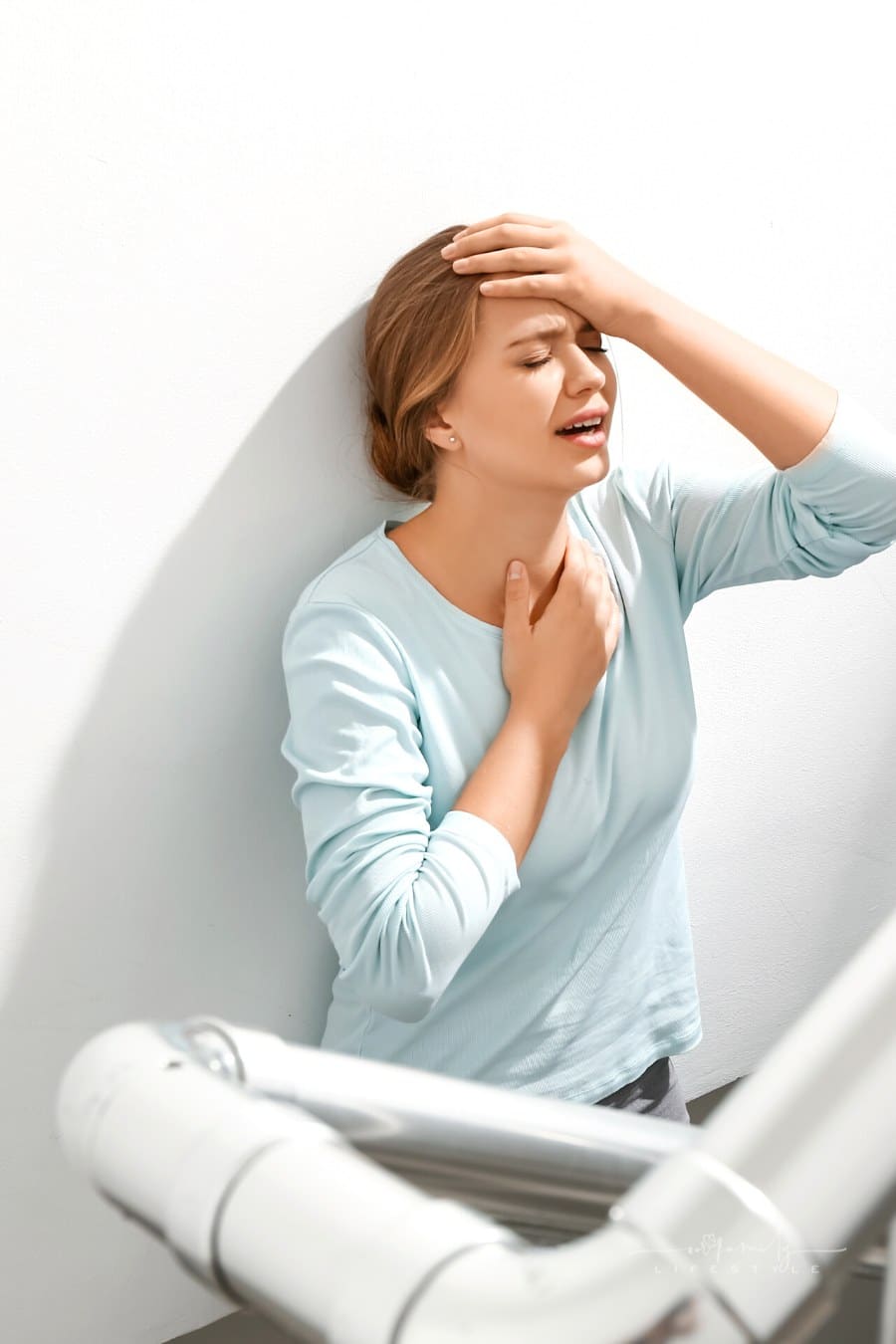 woman having a panic attack in stairwell