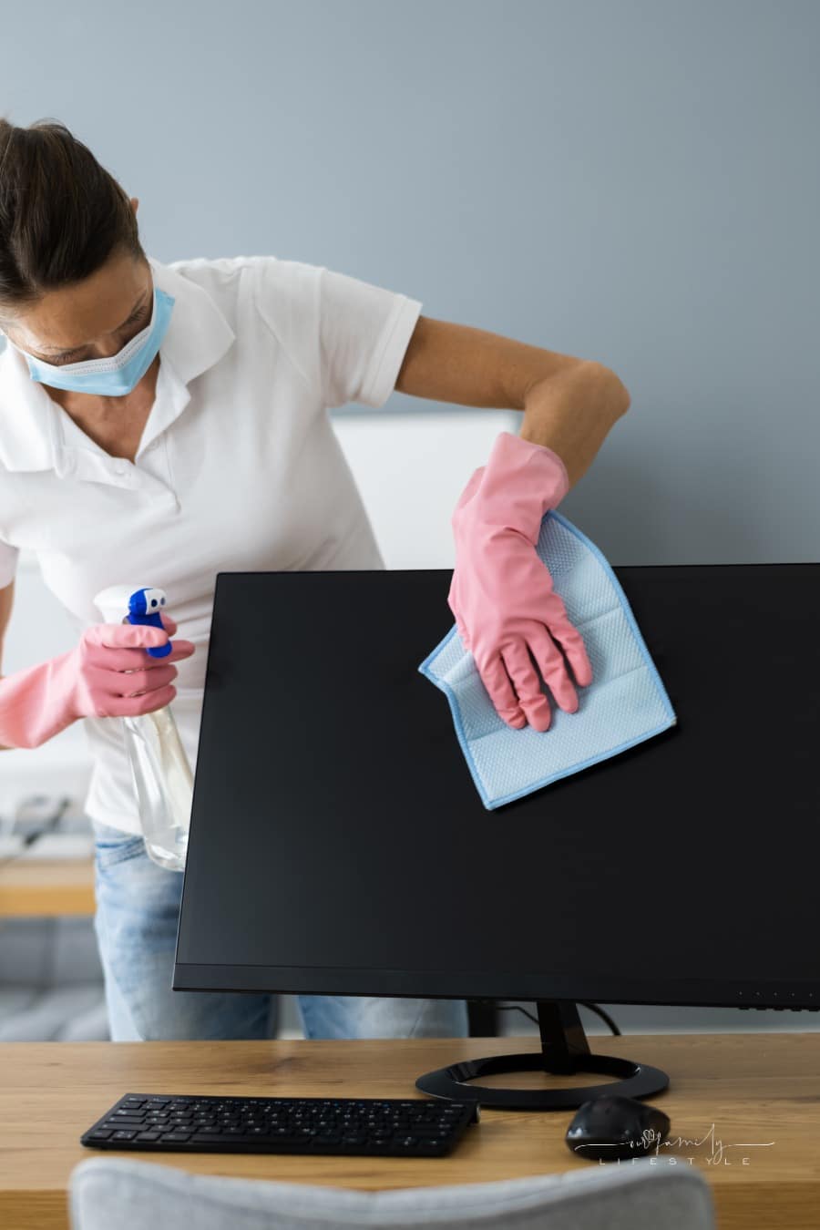 professional cleaner wiping off a computer monitor