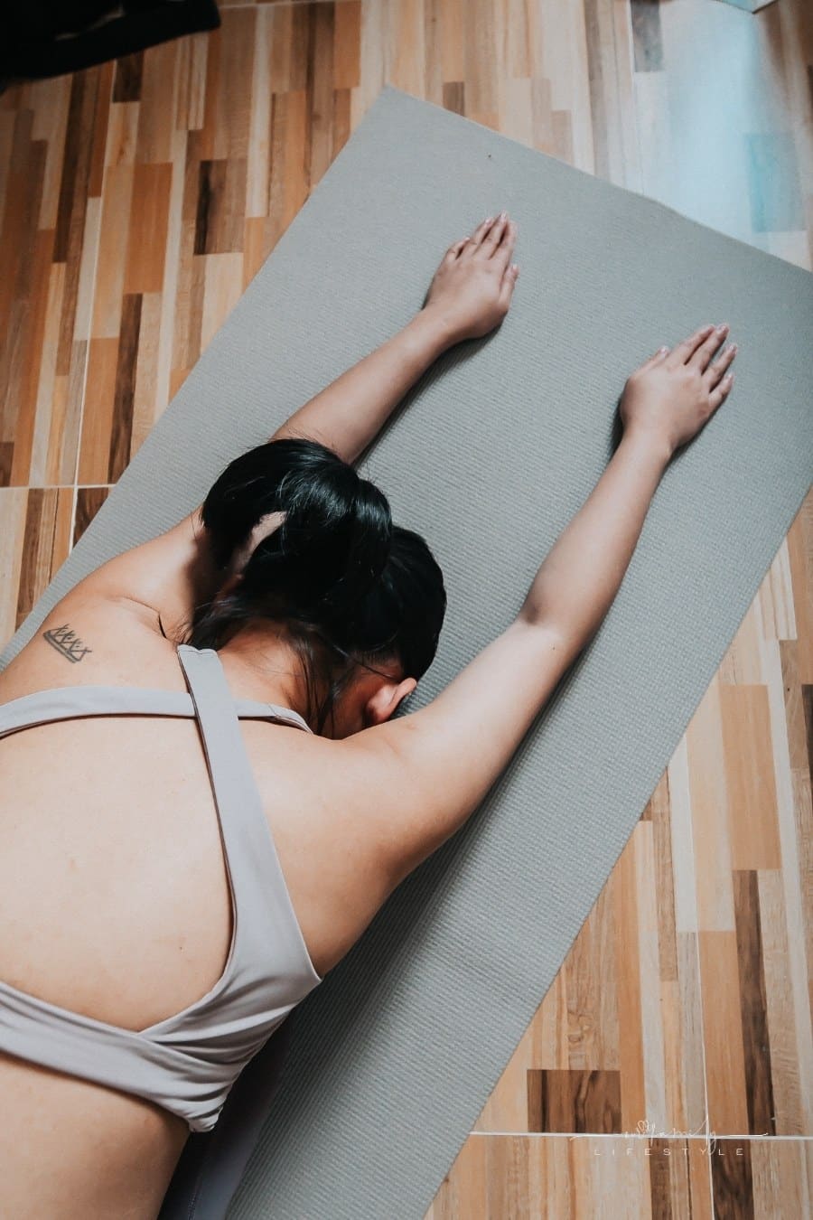 woman doing yoga at home on a mat
