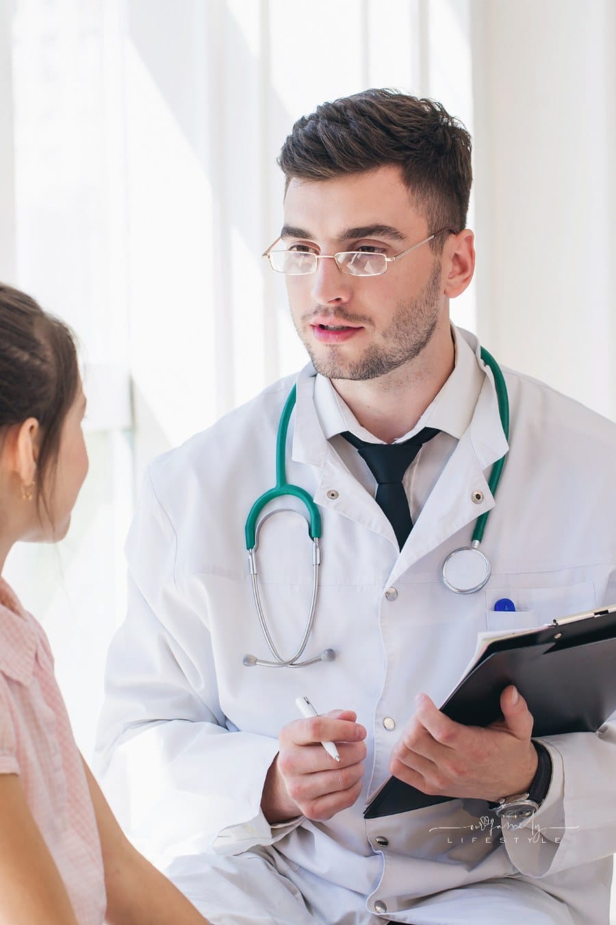 Pediatrician doctor examining child