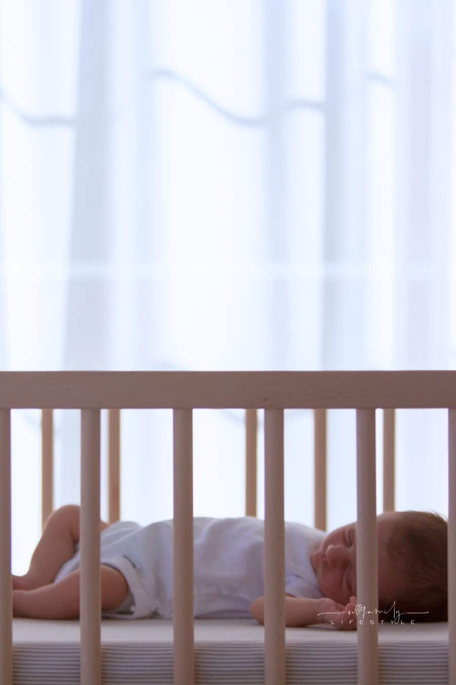newborn baby sleeping in a crib