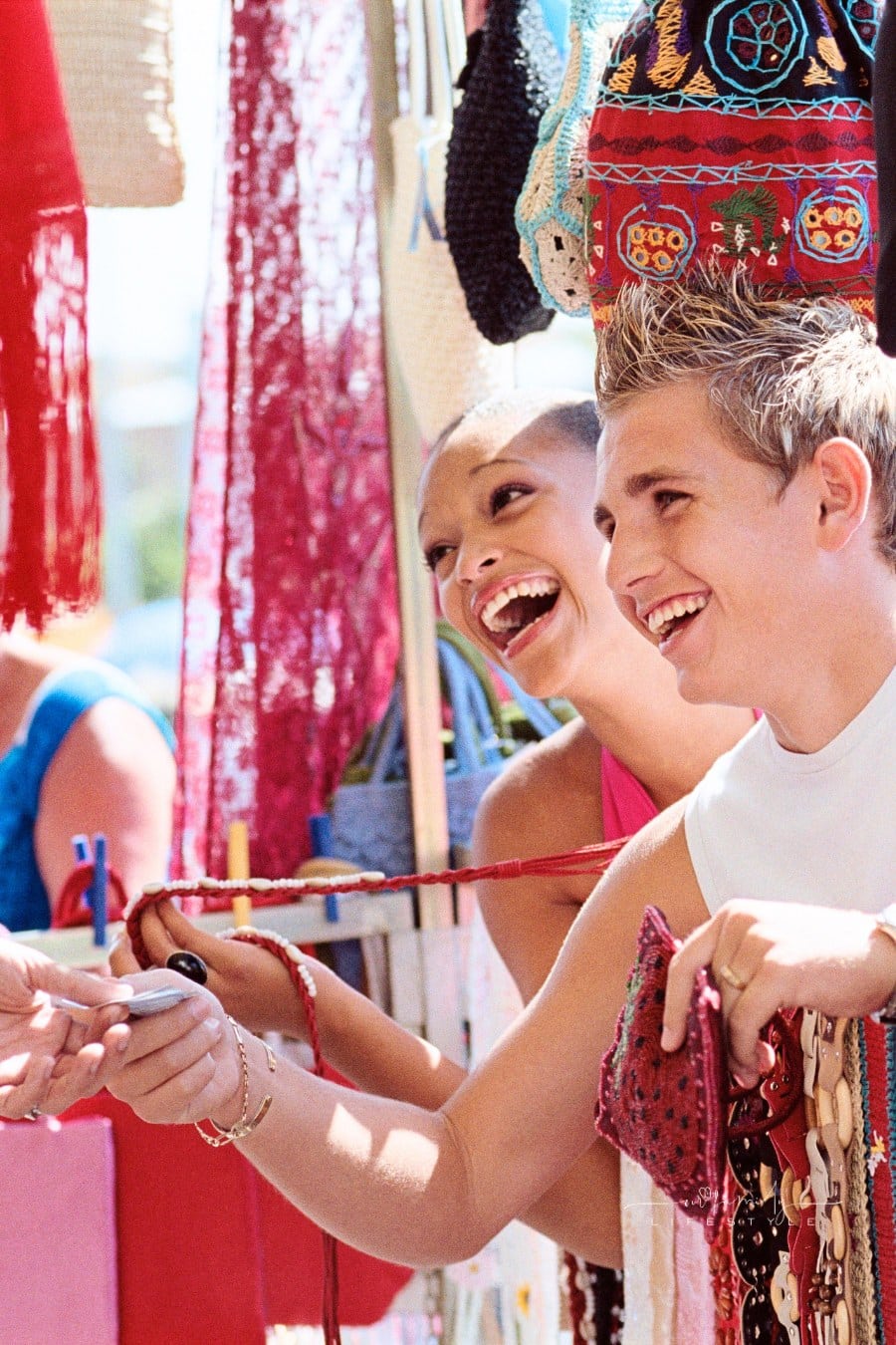 couple paying for goods at outdoor craft market