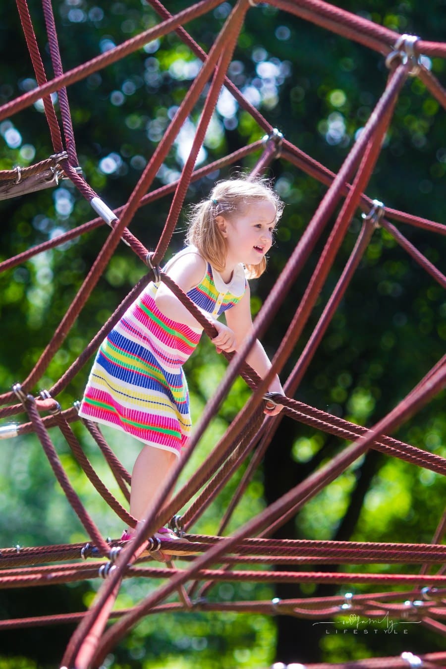 child climbing on monkey bars at a playground
