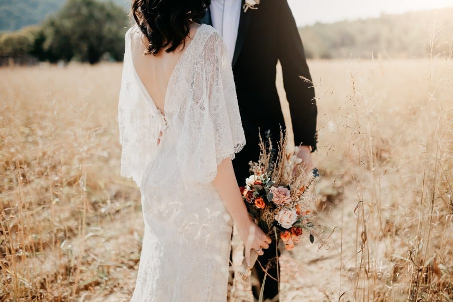 Groom with Bride holding Rustic wedding bouquet