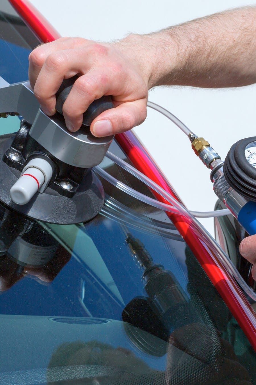 Glazier repairing windscreen after stone chipping damage
