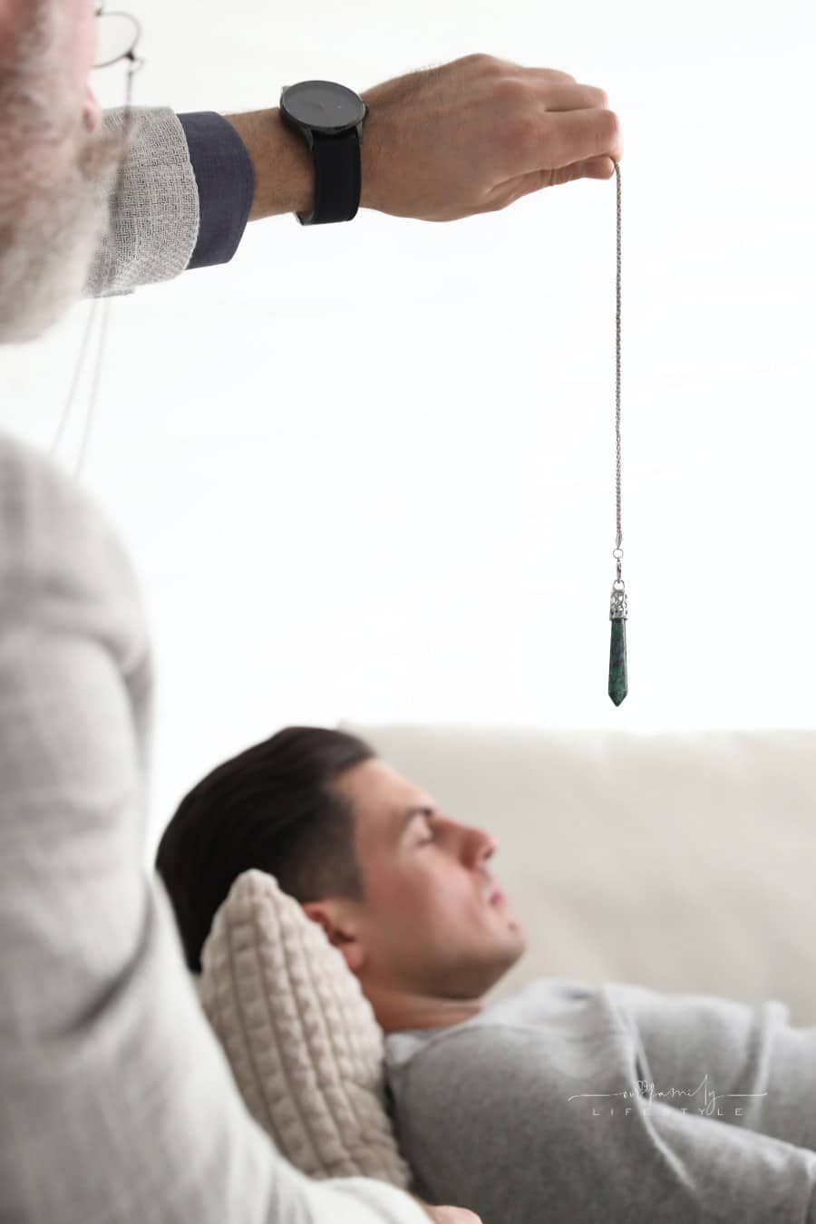 Psychotherapist Using Pendulum during Hypnotherapy Session in
