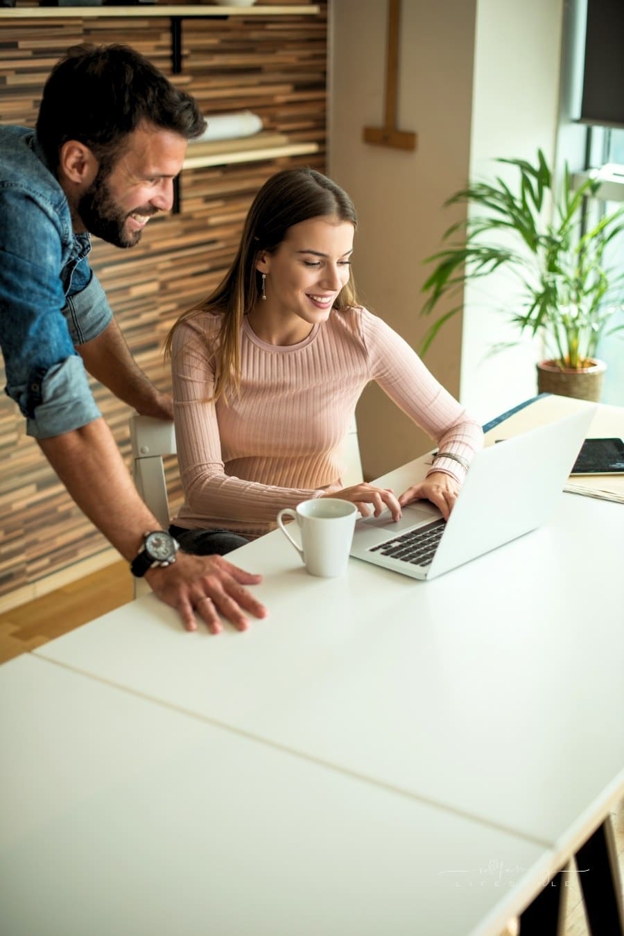 couple working together on laptop at their family business