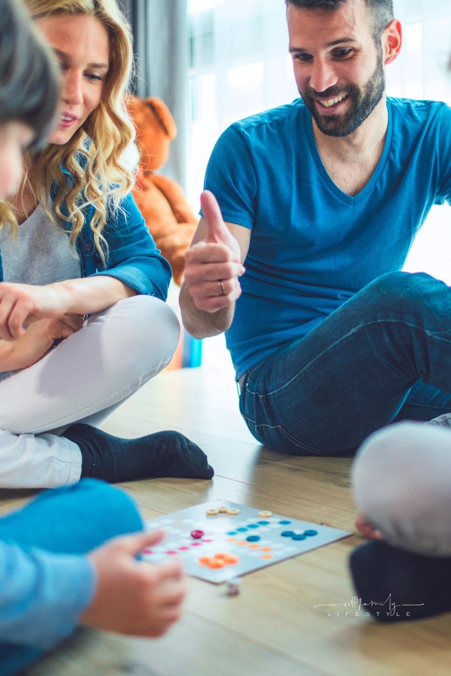Family Playing Board Game At Home