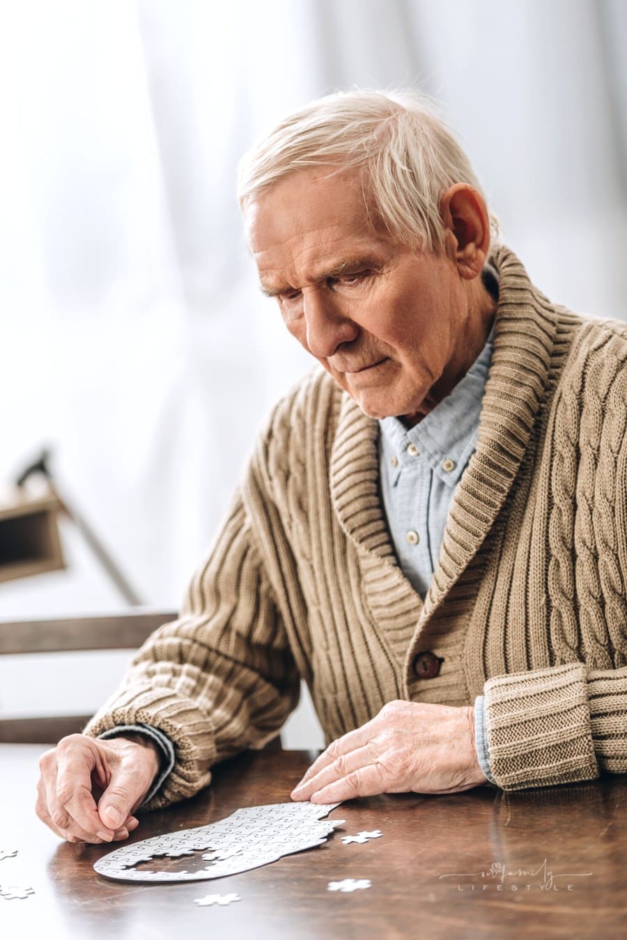 senior dementia patient putting together a puzzle of a head