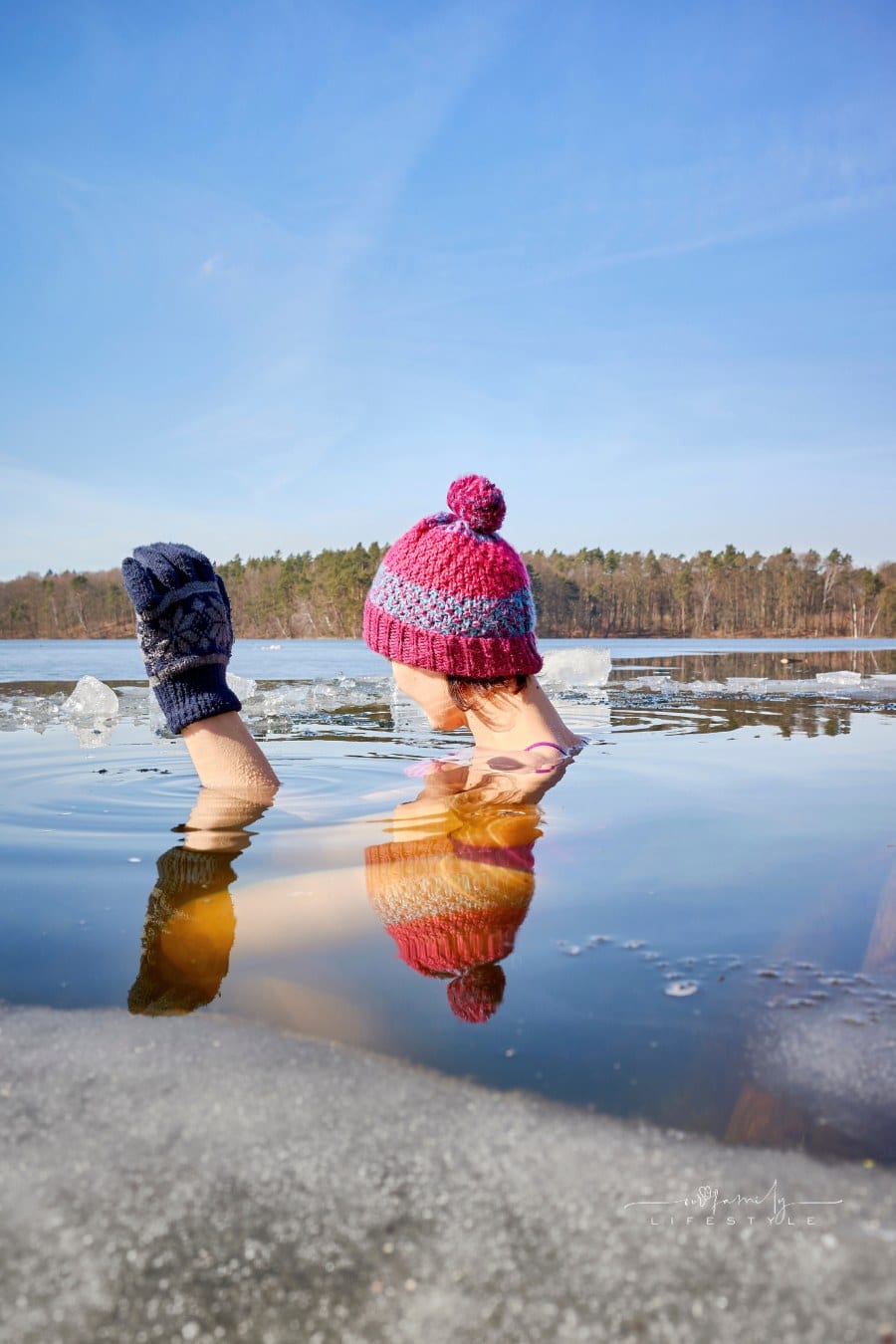 Woman in an Ice Hole wearing gloves and knitted hat.