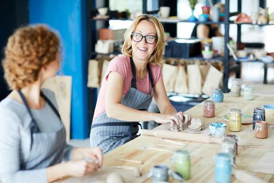 female friends taking a craft class together and laughing