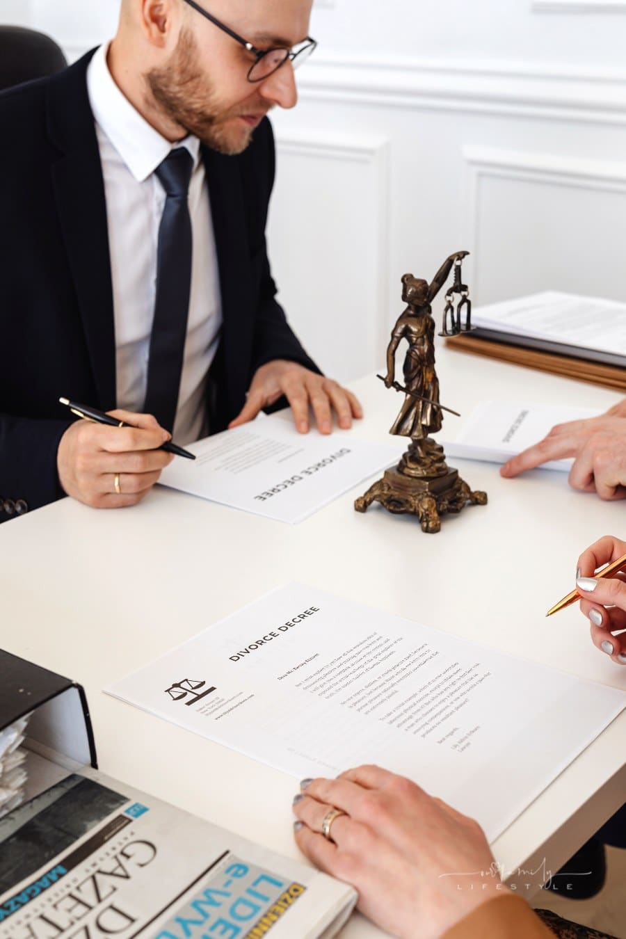 couple signing divorce decree with family lawyer