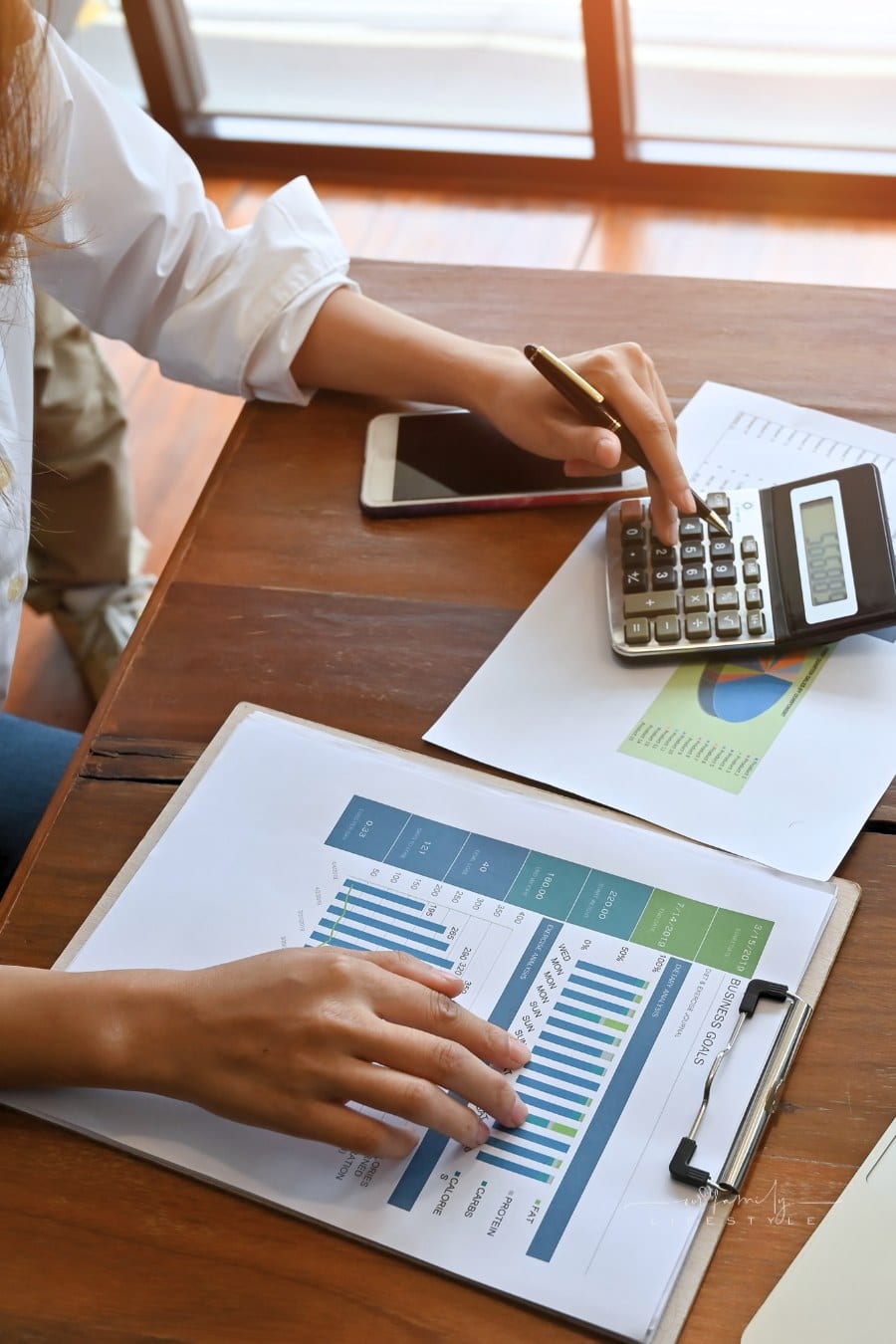 woman working with finance data using a calculator