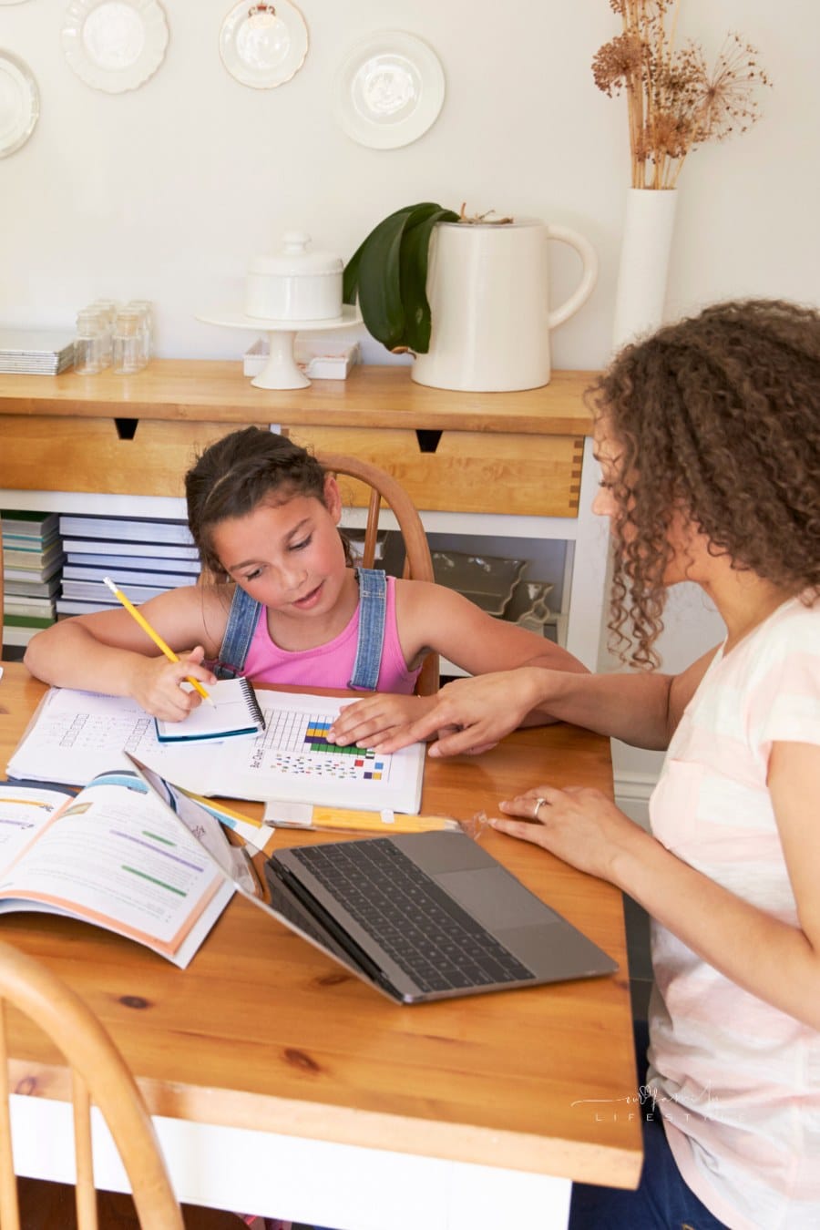 Parents Helping Children with Homeschooling work at Table