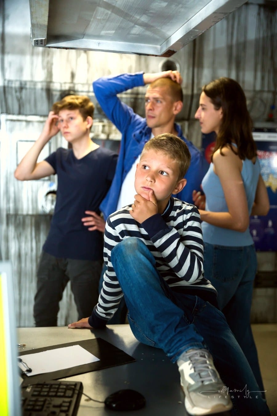 family working together to find solution to escape room puzzle