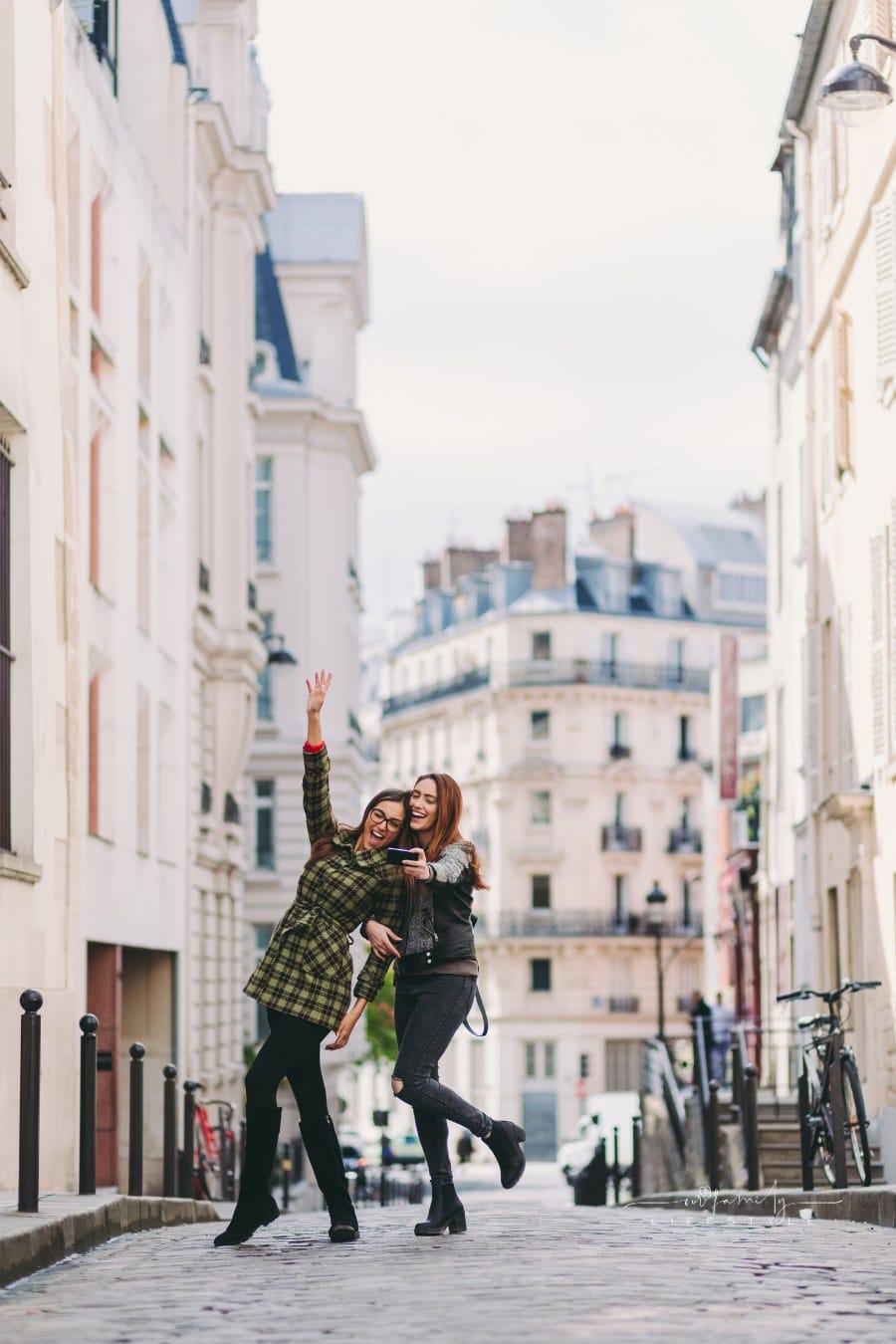 women taking selfie in the middle of city street