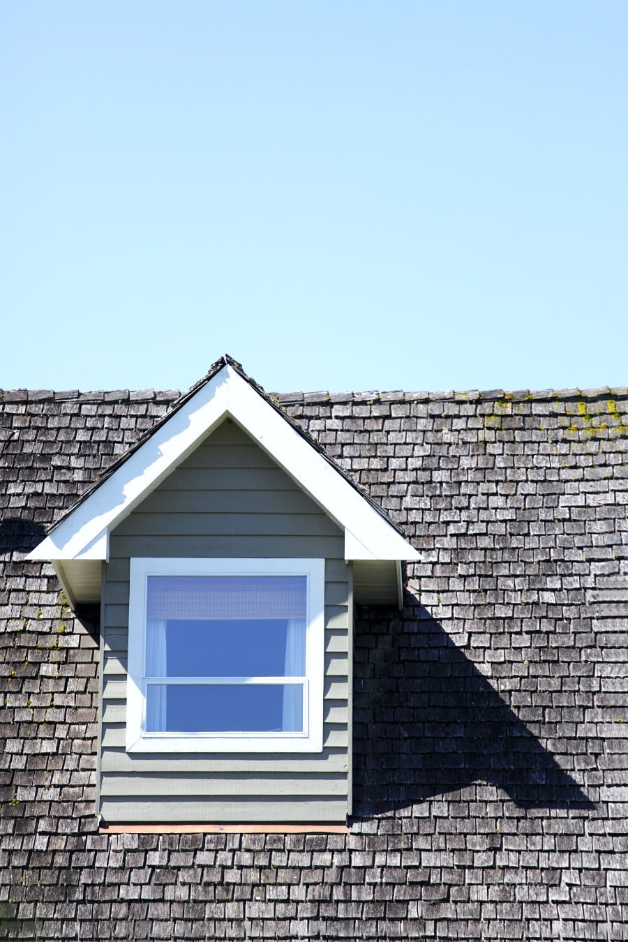 close up view of dormer window on old roof