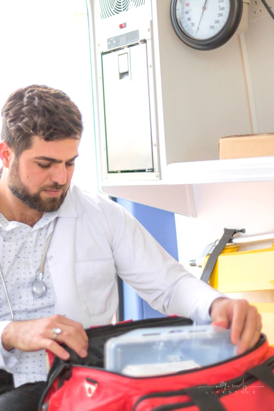 paramedic packing emergency bag in ambulance