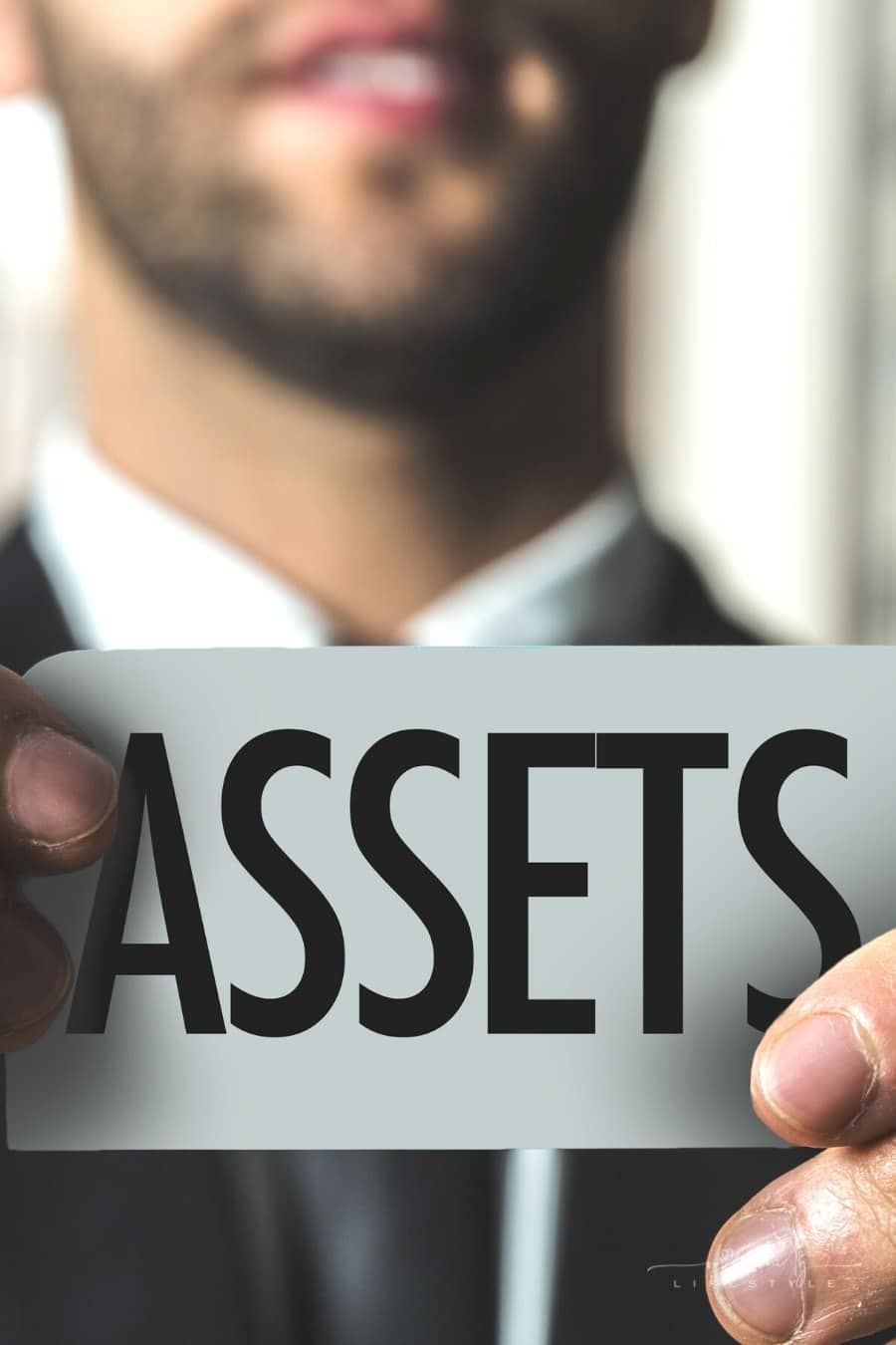 man holding assets sign
