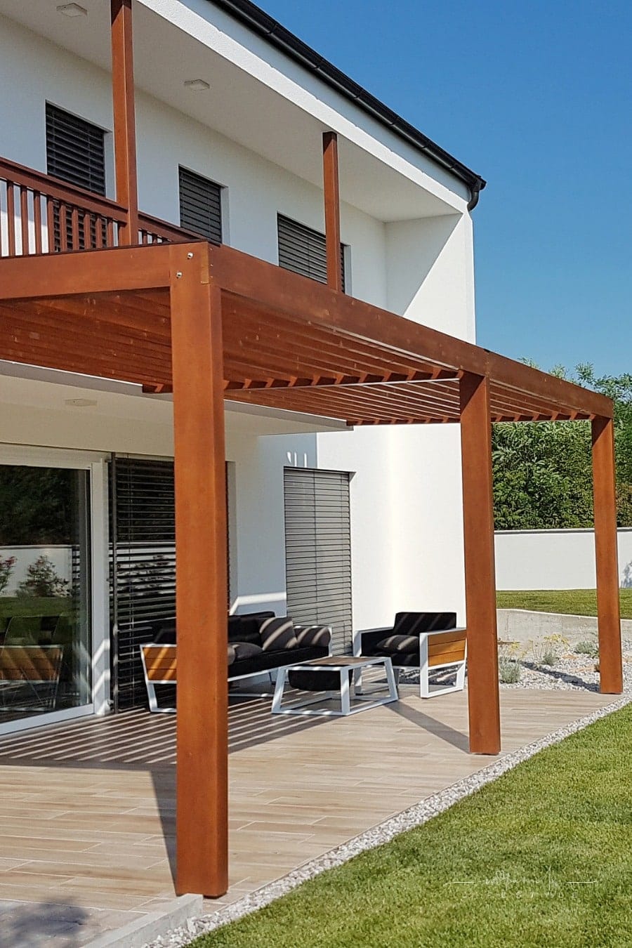 pergola anchored on concrete and attached to a house