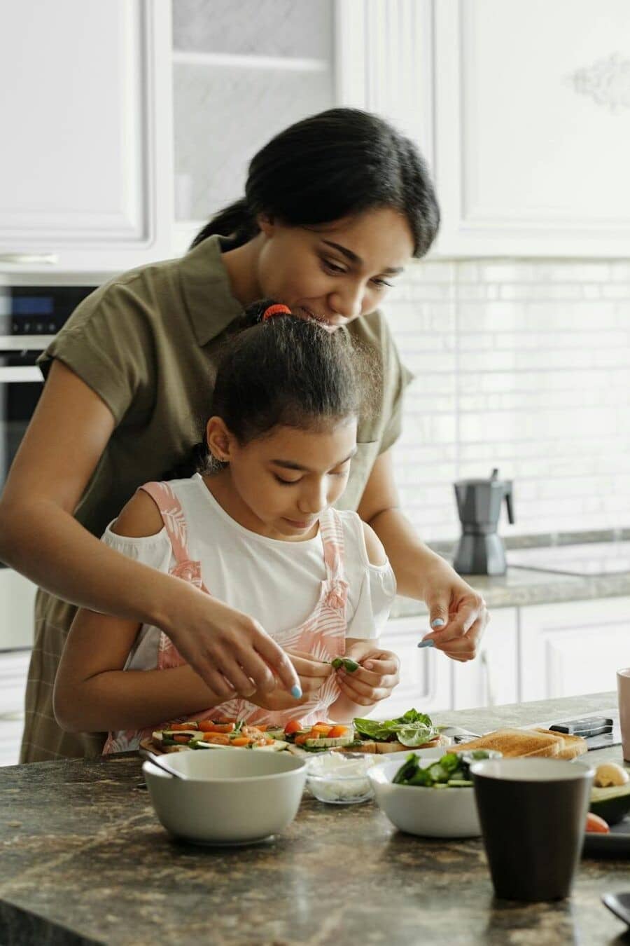 a-mom-and-daughter-share-a-bonding-moment-while-preparing-a-healthy-lunch-together-in-the-kitchen