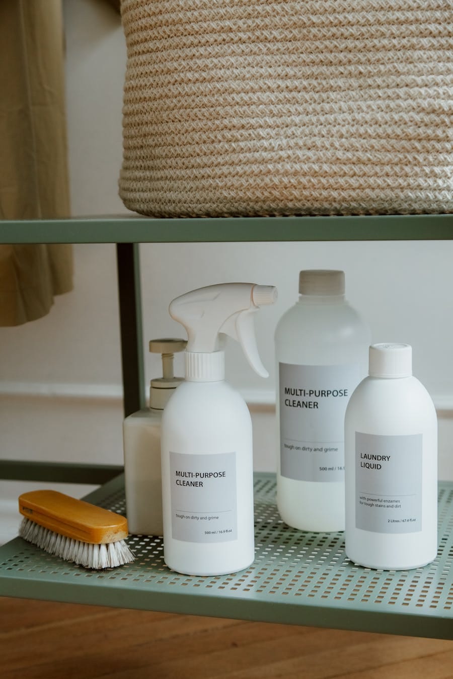A neatly arranged collection of cleaning supplies on a metal shelf.
