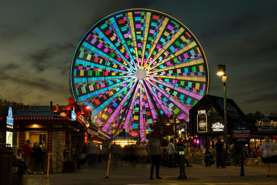 A vibrant Ferris wheel illuminated at night in Pigeon Forge, Tennessee.