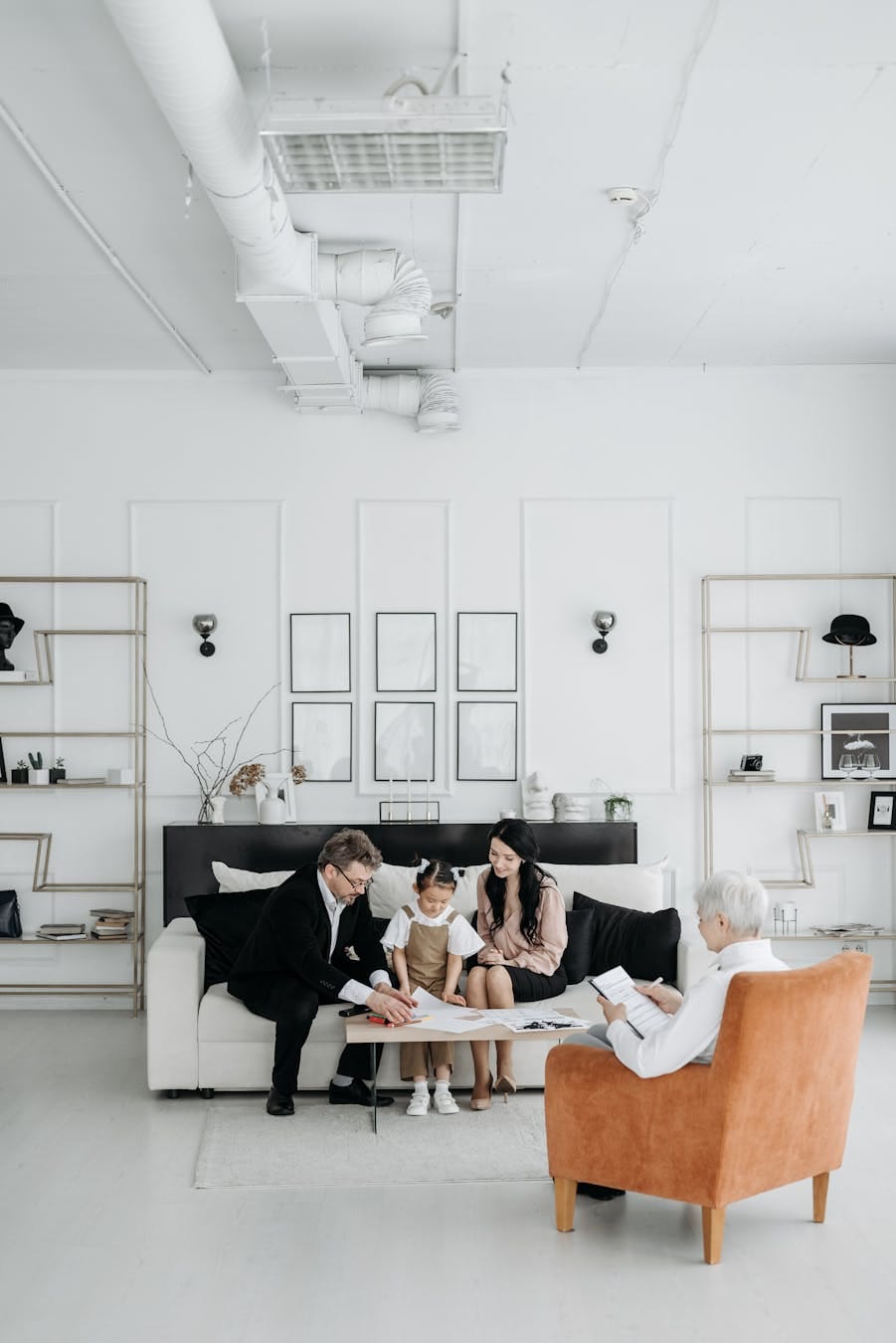Adoptive parents meeting with a social worker and child in a bright, modern office.