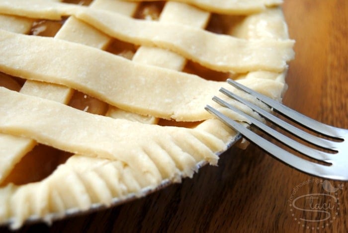 using a fork to pinch the pie crust together
