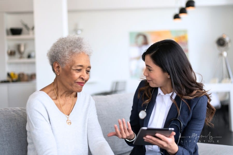Young doctor holding a tablet while explaining care elderly patient