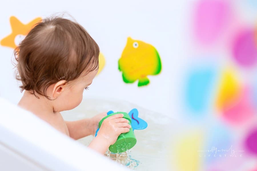 toddler playing with bath toys