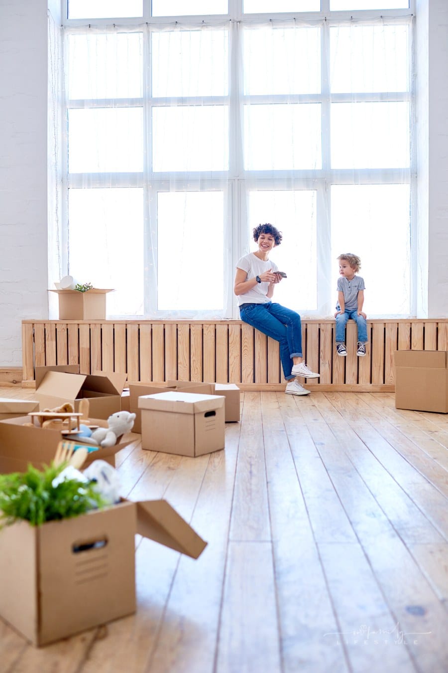 mother and son enjoying view in new apartment