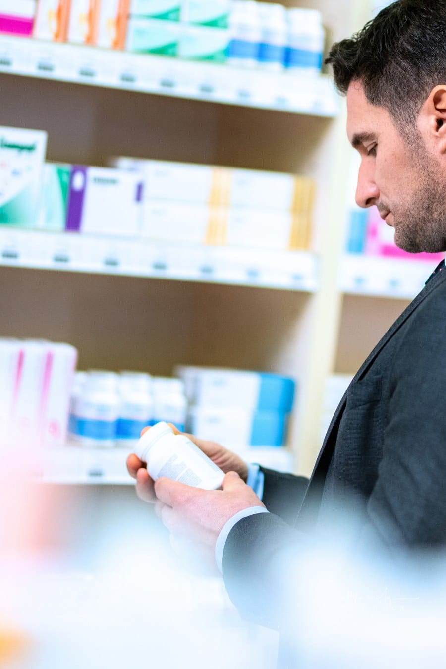 Man reading label of medicine bottle