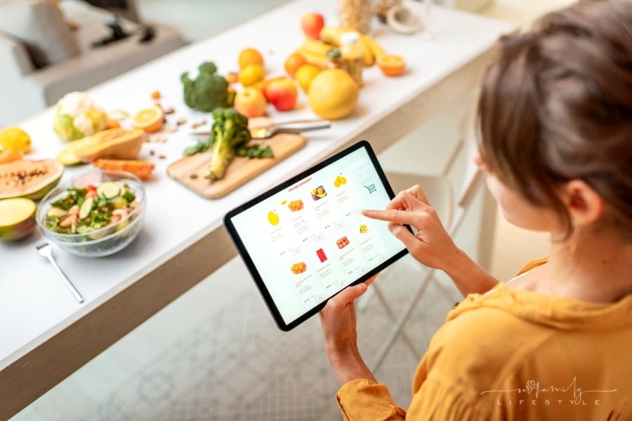woman buying food online using tablet