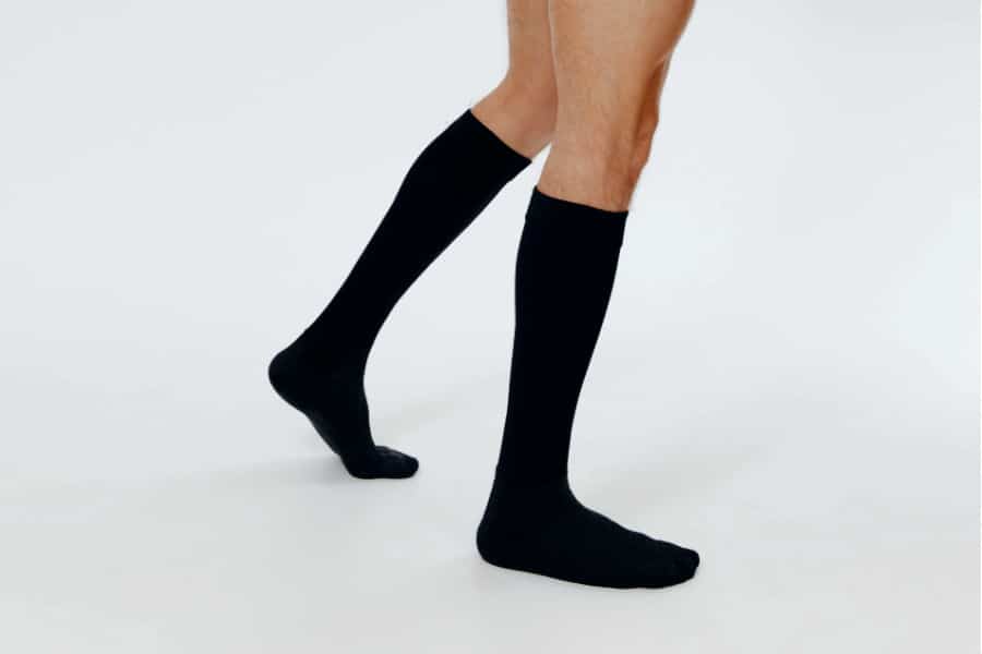 long black socks on man's legs facing sideways