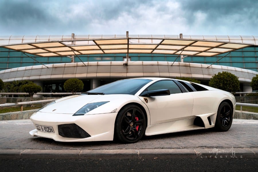 A White Lamborghini Parked in Front a Building