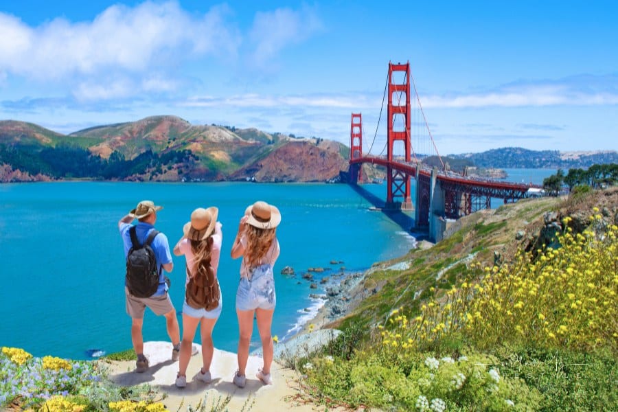 Family enjoying time together on vacation hiking trip. Golden Gate Bridge, over Pacific Ocean, mountains in the background. S