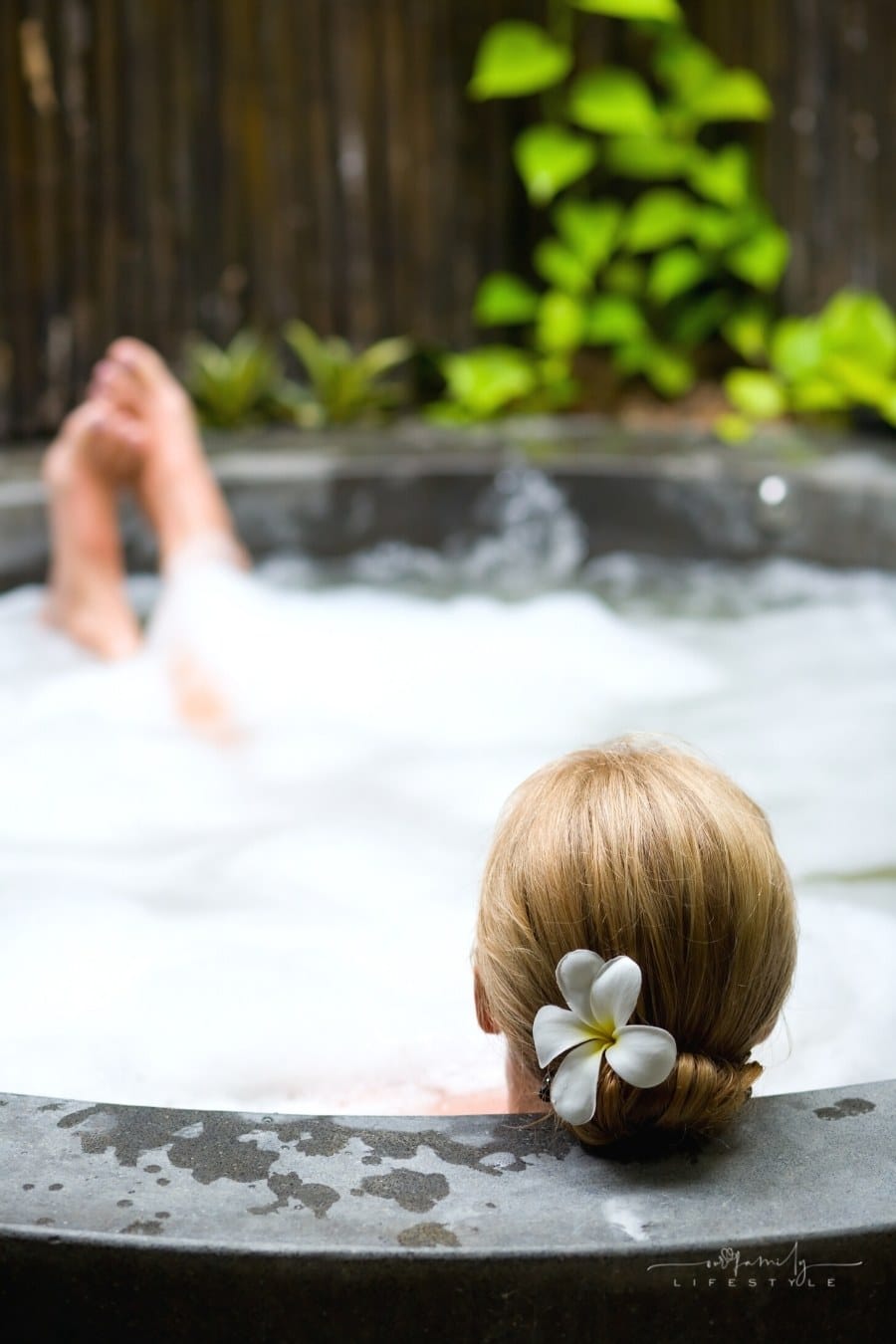woman relaxing in hot tub with feet up