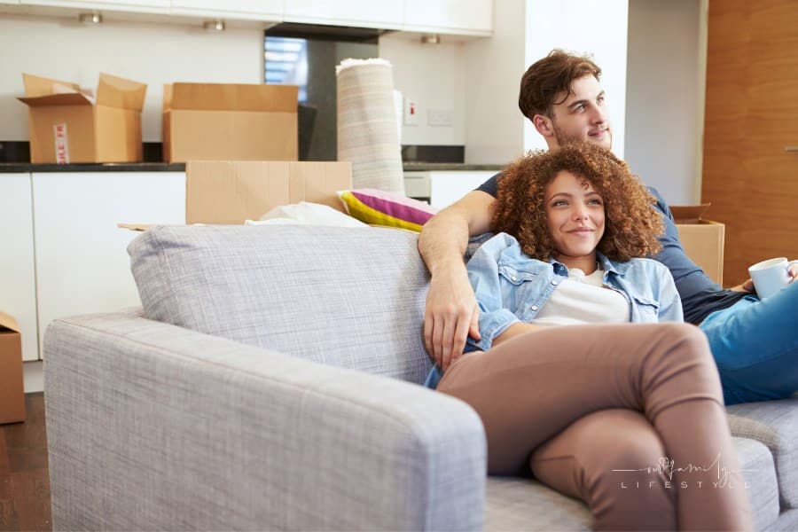 Couple relaxing on sofa in in New Home