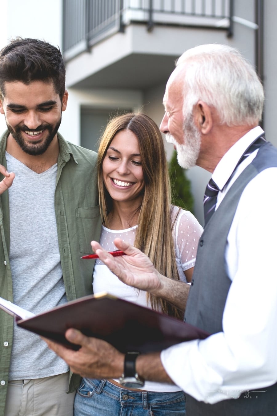 couple talking with real estate agent buying new house