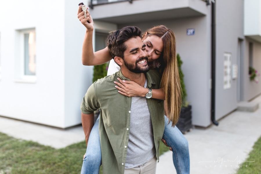 couple celebrating with keys to new house