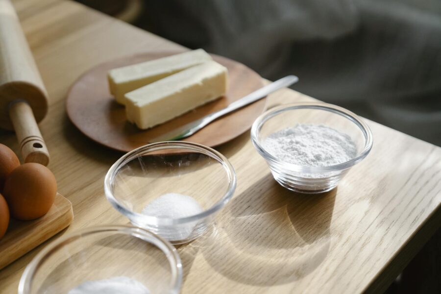 Close-up of baking ingredients on a wooden table with natural lighting.