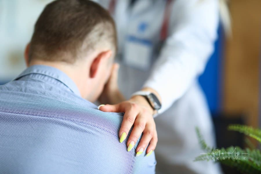 Doctor Put Her Hand Sympathetically on Shoulder of Upset Male Patient