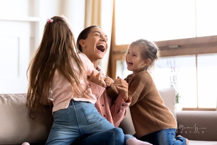 daughters tickling simple mom on sofa
