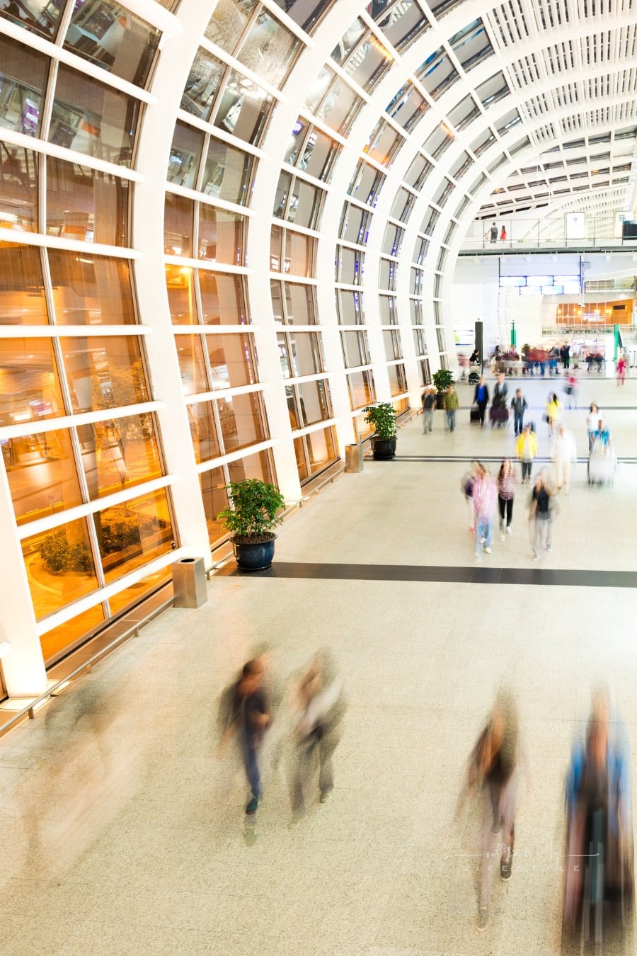 people walking thorugh airport at blurred speed