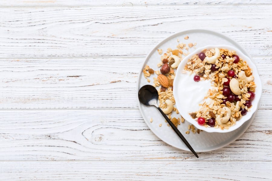 Healthy breakfast food with granola, yogurt, fruits and nuts. Yogurt parfait with dried fruits for breakfast