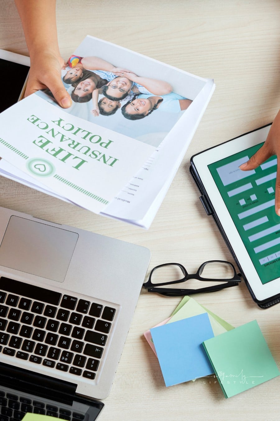 Filling out life insurance form on tablet